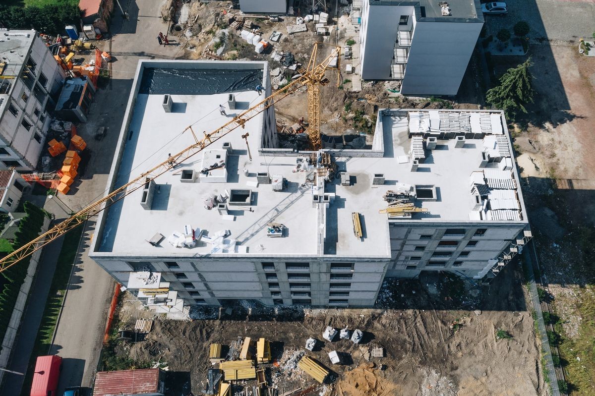 Aerial view on building construction site. Construction of multi-family house